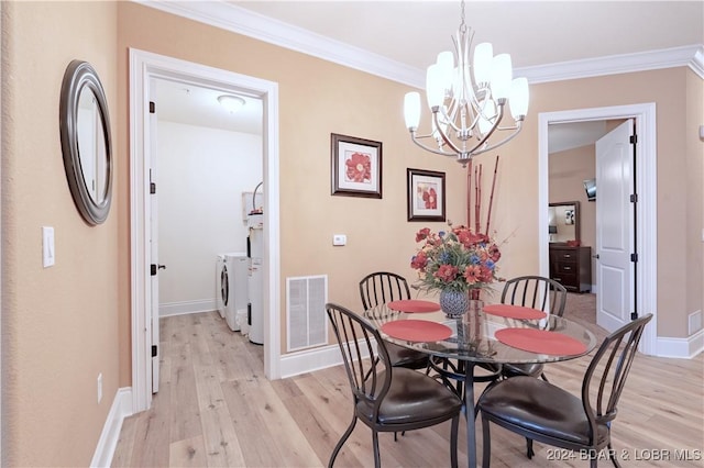 dining room featuring light hardwood / wood-style flooring, independent washer and dryer, a chandelier, and crown molding