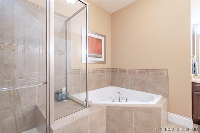 bathroom with shower with separate bathtub, tile patterned flooring, and vanity