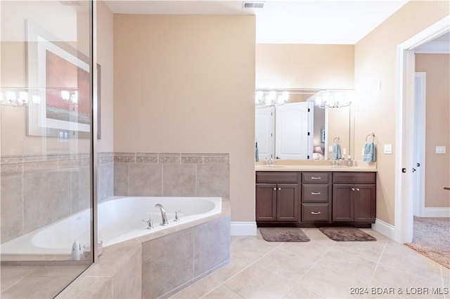 bathroom featuring vanity, tile patterned flooring, and tiled bath