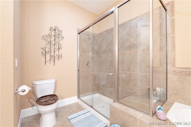 bathroom with plus walk in shower, tile patterned flooring, and toilet