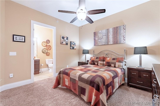 carpeted bedroom featuring ceiling fan and ensuite bathroom