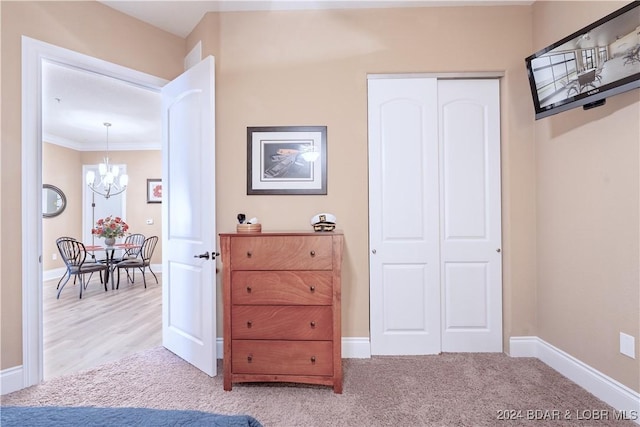 interior space featuring a chandelier, carpet, and crown molding