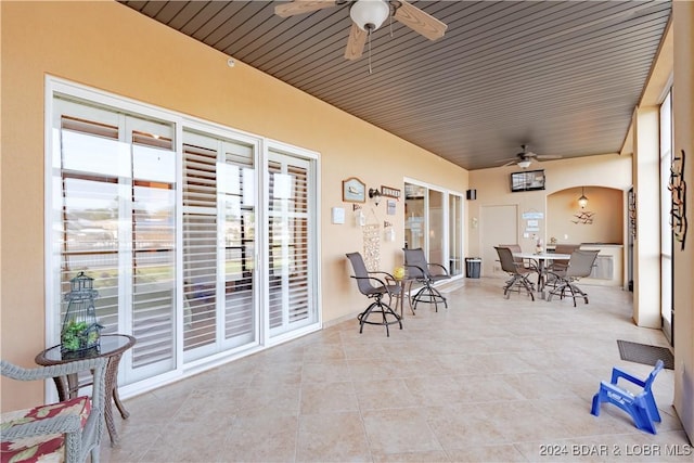 sunroom / solarium featuring wooden ceiling and ceiling fan