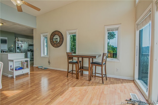 dining room with a healthy amount of sunlight, ceiling fan, and light hardwood / wood-style floors