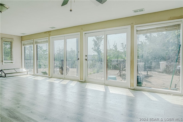 entryway featuring plenty of natural light, ceiling fan, and light hardwood / wood-style flooring