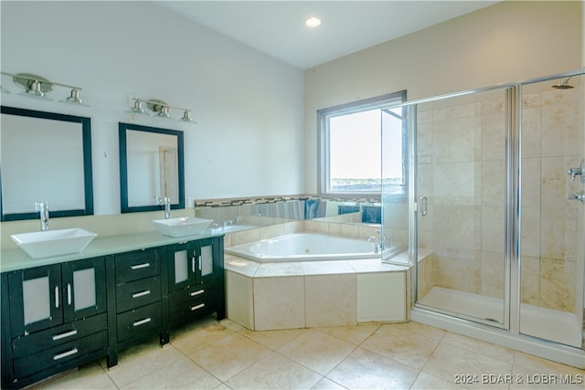 bathroom with tile patterned floors, vanity, and separate shower and tub