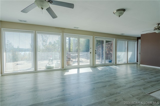 unfurnished room with hardwood / wood-style flooring and ceiling fan