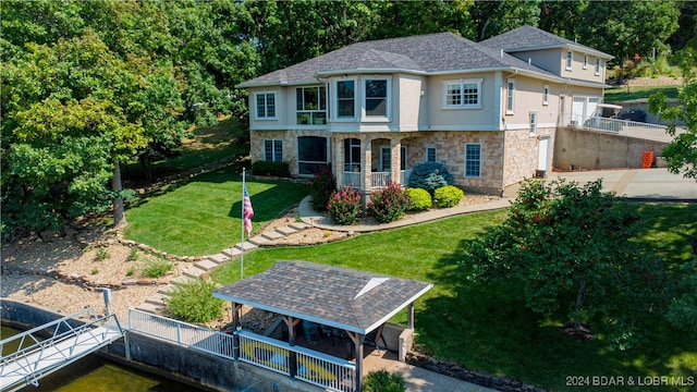 rear view of property featuring a yard