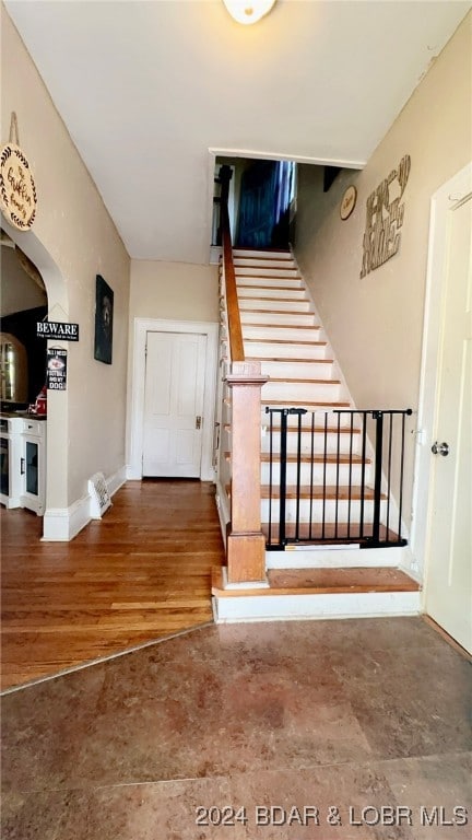 stairway with hardwood / wood-style floors