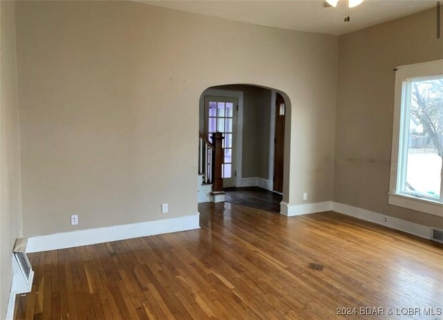 empty room with hardwood / wood-style flooring