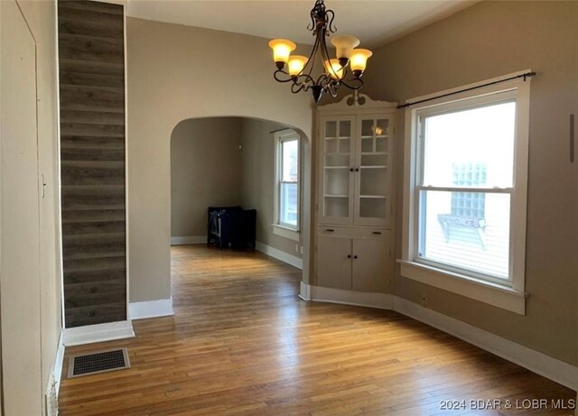 interior space featuring an inviting chandelier and light wood-type flooring