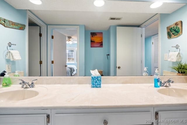 bathroom with ceiling fan and dual bowl vanity