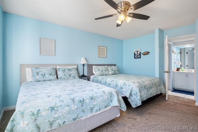 carpeted bedroom featuring ceiling fan and ensuite bath