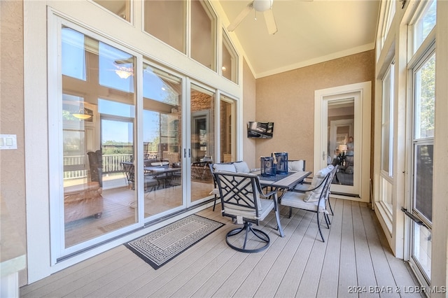 sunroom / solarium featuring ceiling fan