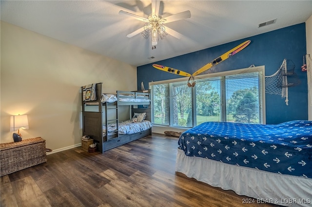 bedroom with ceiling fan, wood-type flooring, and vaulted ceiling