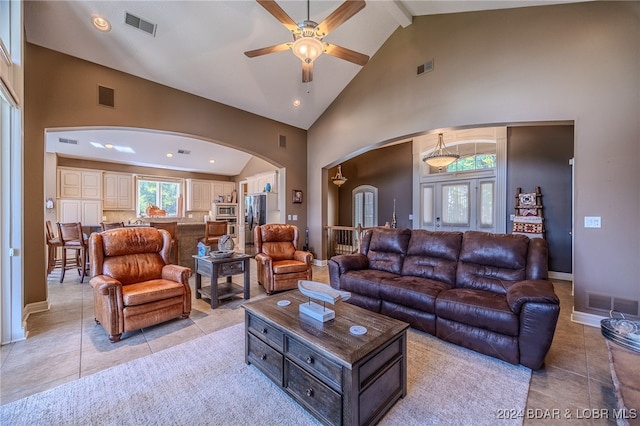 living room featuring beamed ceiling, ceiling fan, high vaulted ceiling, and light tile patterned floors