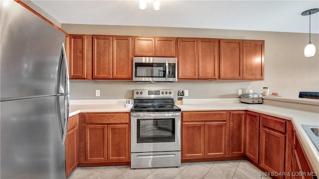 329 Bristol Bay Dr Unit 3B, Lake Ozark, MO 65049 - kitchen featuring appliances with stainless steel finishes, brown cabinets, and light countertops