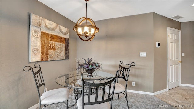 dining room featuring light tile patterned floors and a notable chandelier