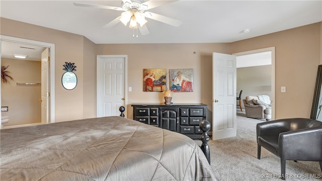 bedroom featuring ensuite bath, ceiling fan, and carpet