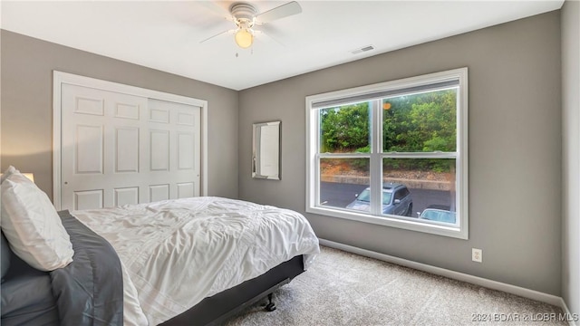 329 Bristol Bay Dr Unit 3B, Lake Ozark, MO 65049 - bedroom with baseboards, carpet floors, a closet, and ceiling fan