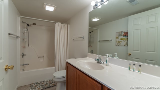 full bathroom with vanity, shower / tub combo, tile patterned floors, and toilet