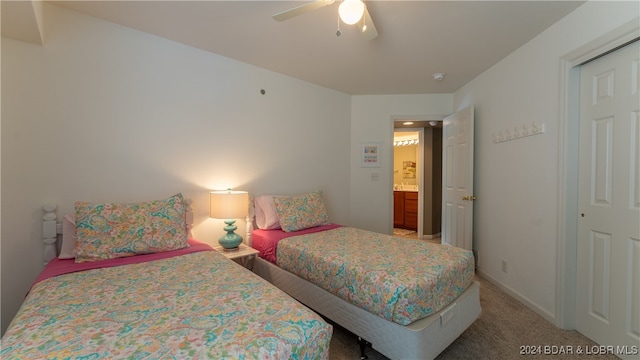 carpeted bedroom with ceiling fan and a closet