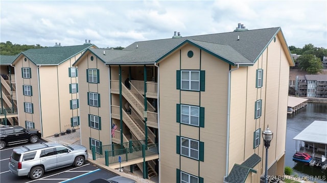 329 Bristol Bay Dr Unit 3B, Lake Ozark, MO 65049 - view of building exterior with uncovered parking and stairway