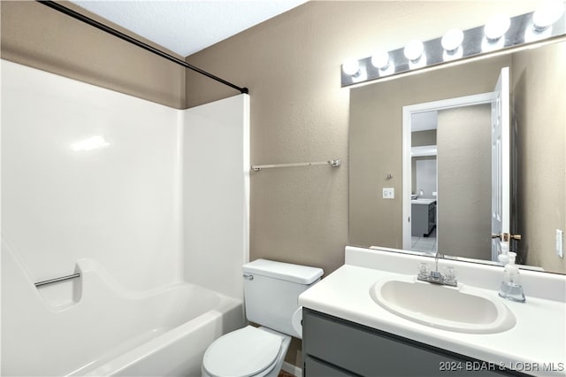 full bathroom with vanity, bathtub / shower combination, a textured ceiling, and toilet