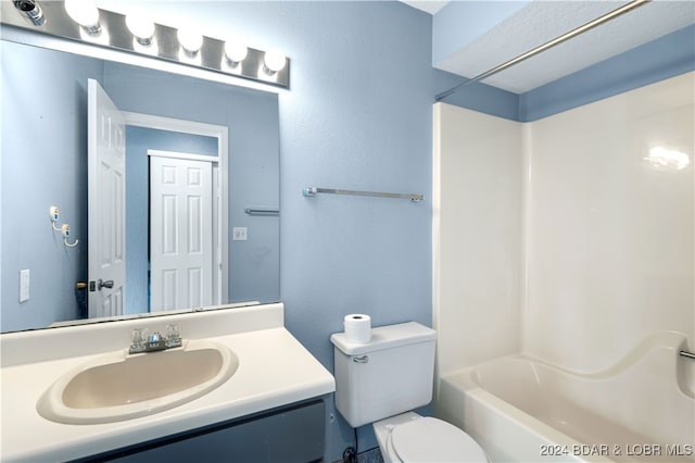 full bathroom with vanity,  shower combination, and toilet