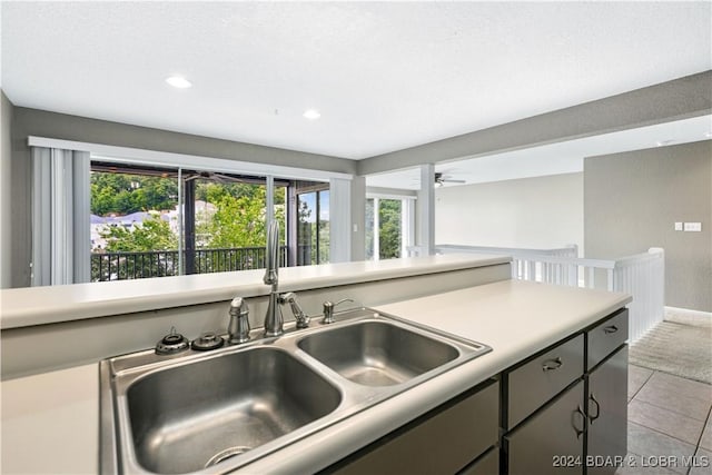 kitchen with ceiling fan, light tile patterned flooring, and sink