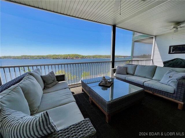 exterior space featuring an outdoor living space, ceiling fan, and a water view