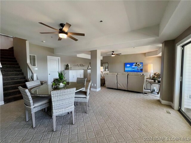 carpeted dining space featuring ceiling fan