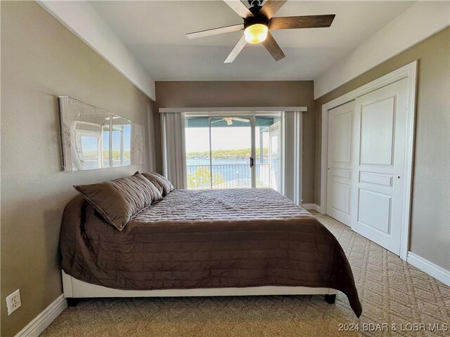 bedroom featuring ceiling fan, light carpet, a closet, and access to exterior