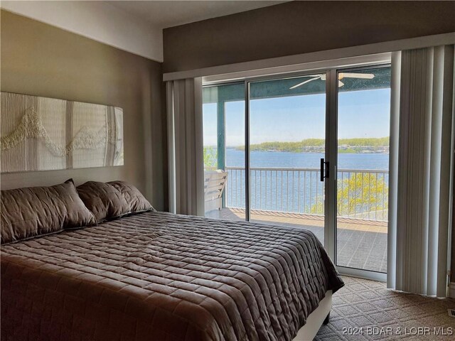 carpeted bedroom featuring access to exterior and a water view