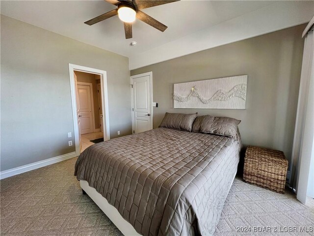 bedroom with ceiling fan and light carpet