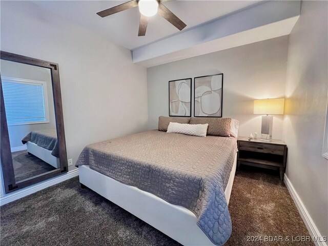 bedroom with ceiling fan and dark colored carpet