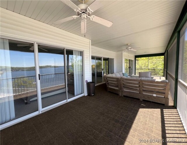 unfurnished sunroom featuring ceiling fan