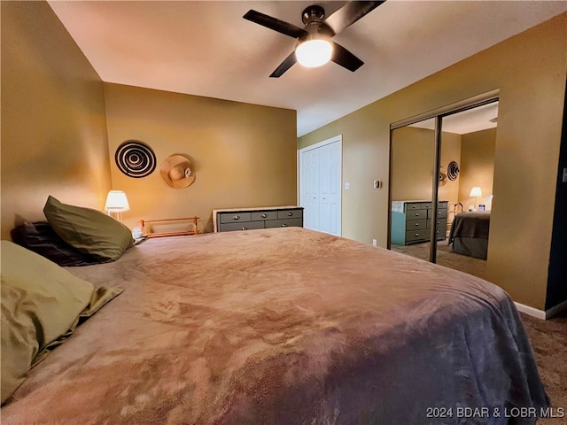 carpeted bedroom featuring two closets and ceiling fan