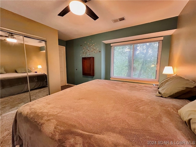 bedroom featuring carpet floors, a closet, and ceiling fan