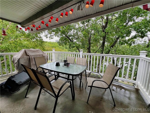 wooden balcony with area for grilling, ceiling fan, and a deck