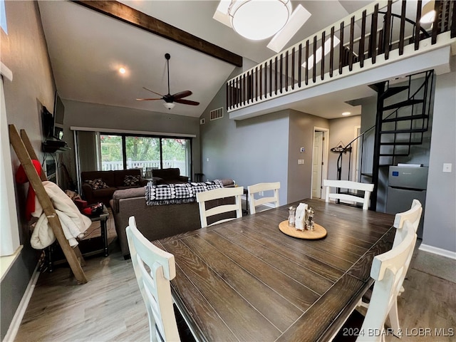 dining space with beamed ceiling, ceiling fan, high vaulted ceiling, and light wood-type flooring