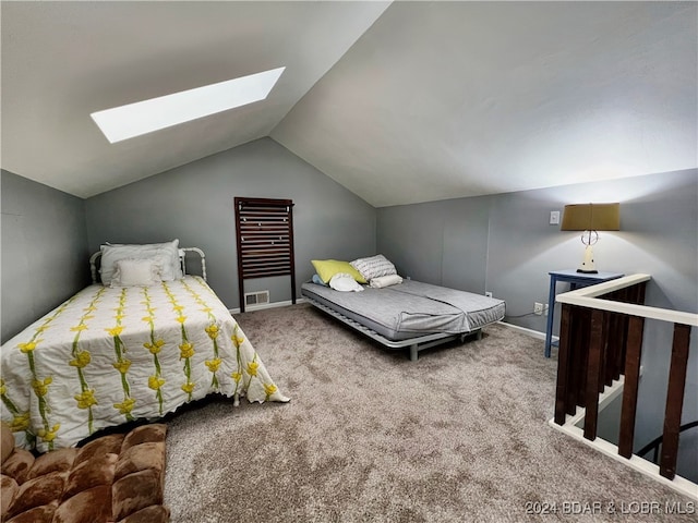 carpeted bedroom with vaulted ceiling with skylight