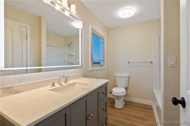 full bathroom featuring vanity, toilet, wood-type flooring, and shower / washtub combination