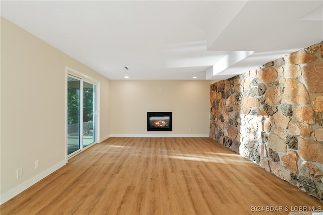 unfurnished living room with light hardwood / wood-style flooring and a fireplace