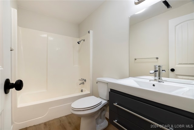 full bathroom with vanity, toilet, bathing tub / shower combination, and wood-type flooring