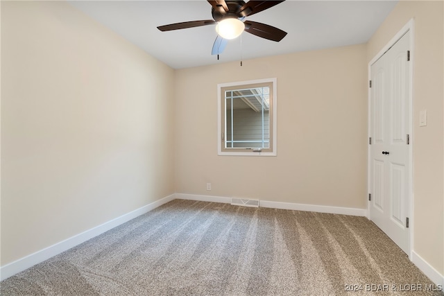 empty room featuring carpet flooring and ceiling fan