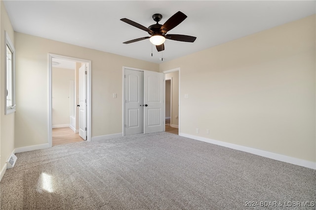 unfurnished bedroom with connected bathroom, a closet, and ceiling fan