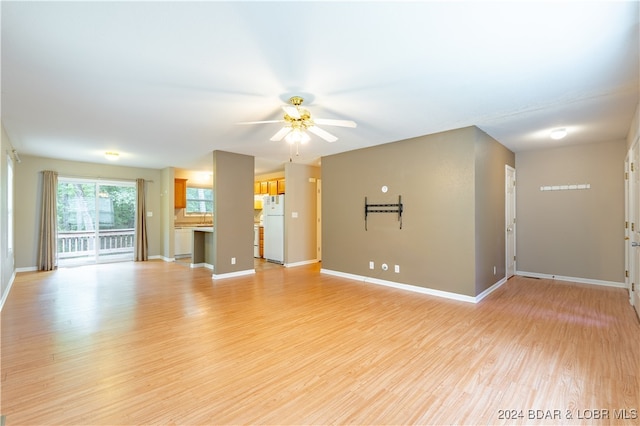 unfurnished living room with light hardwood / wood-style flooring and ceiling fan