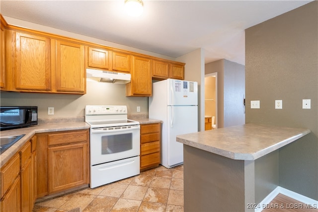 kitchen with sink, white appliances, and kitchen peninsula