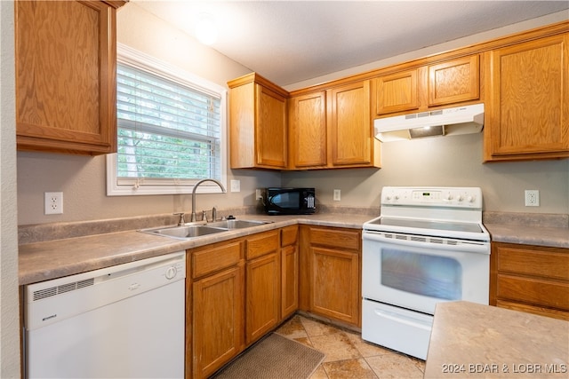 kitchen featuring white appliances and sink